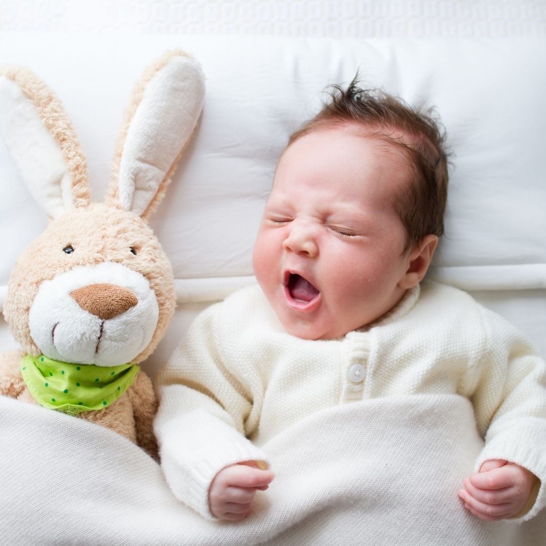 Newborn baby with soft bunny rabbit toy