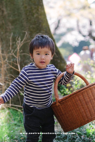 A child carries a basket.