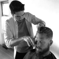 Jay Small, Stylist and co-founder of Arey, cuts a client’s hair