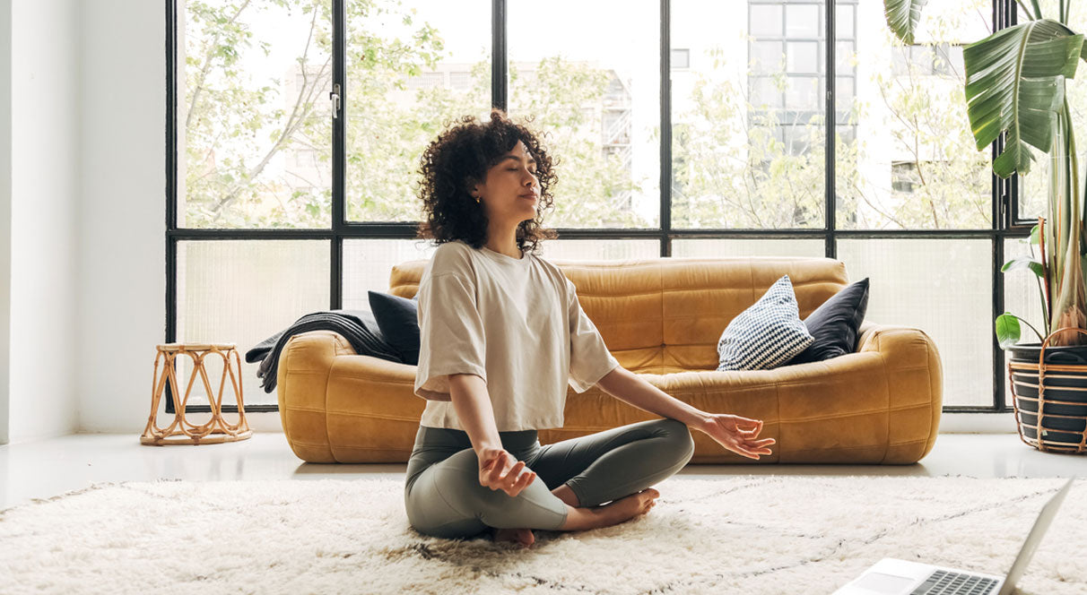 woman meditating to improve her gut microbiome and hair health