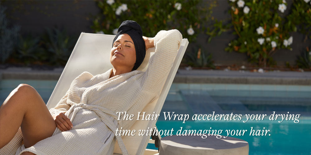 woman wearing a hair towel lying in the sun by the pool