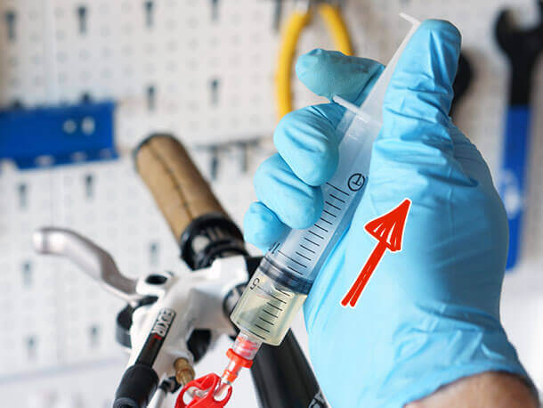 pulling back on avid bleed kit syringe plunger during brake bleeding