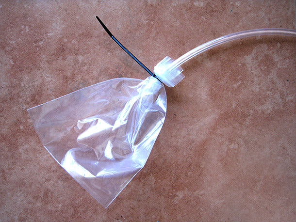 plastic bag with tubing secured inside for brake bleeding