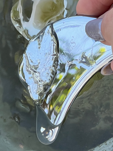 Washing Stainless Steal Gua Sha under warm water