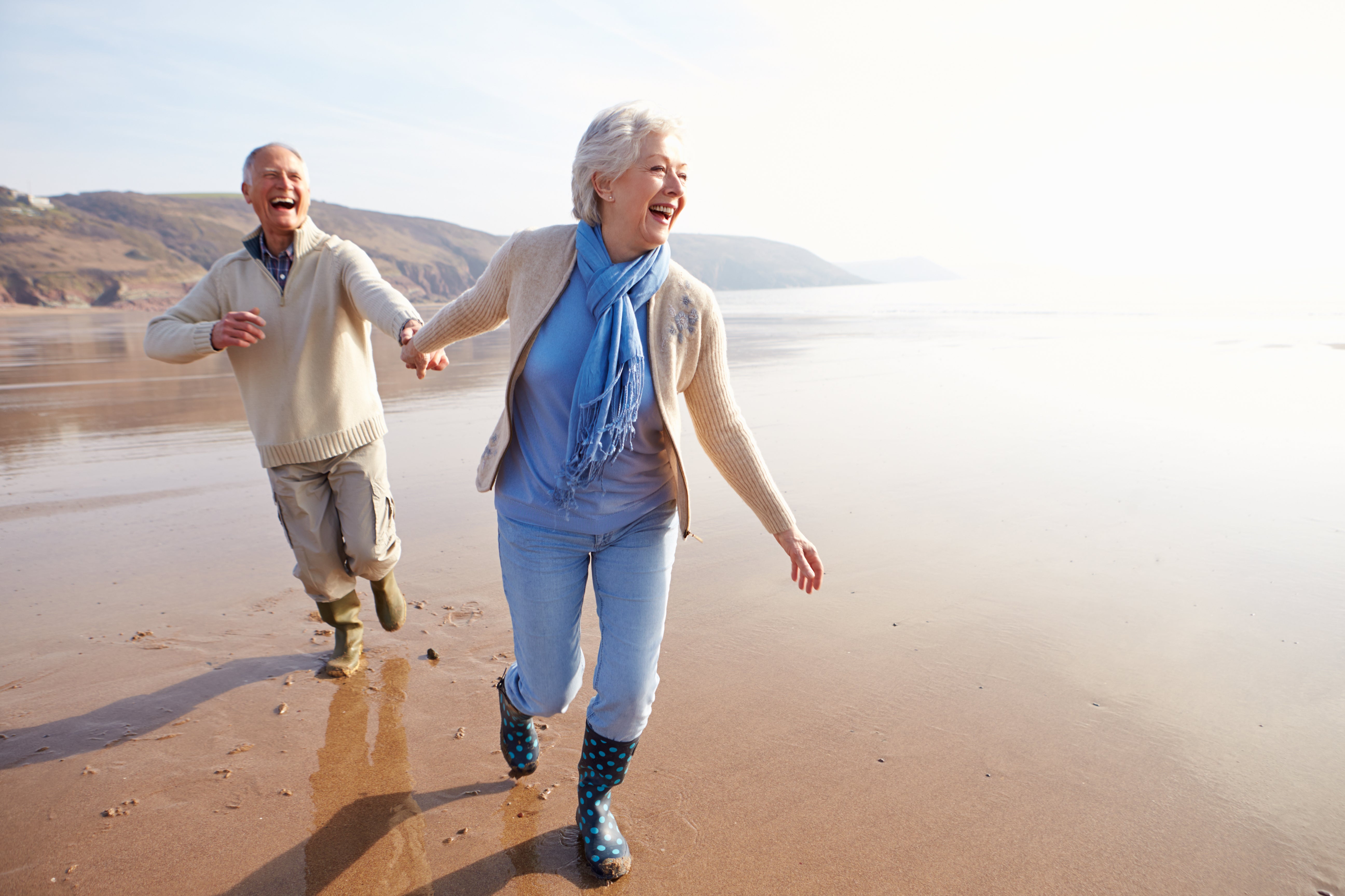 happy elderly couple on beach | 6 Ways Cannabis Shows Promise To Relieve Chronic Disease In Seniors | Blumenes CBD Blog