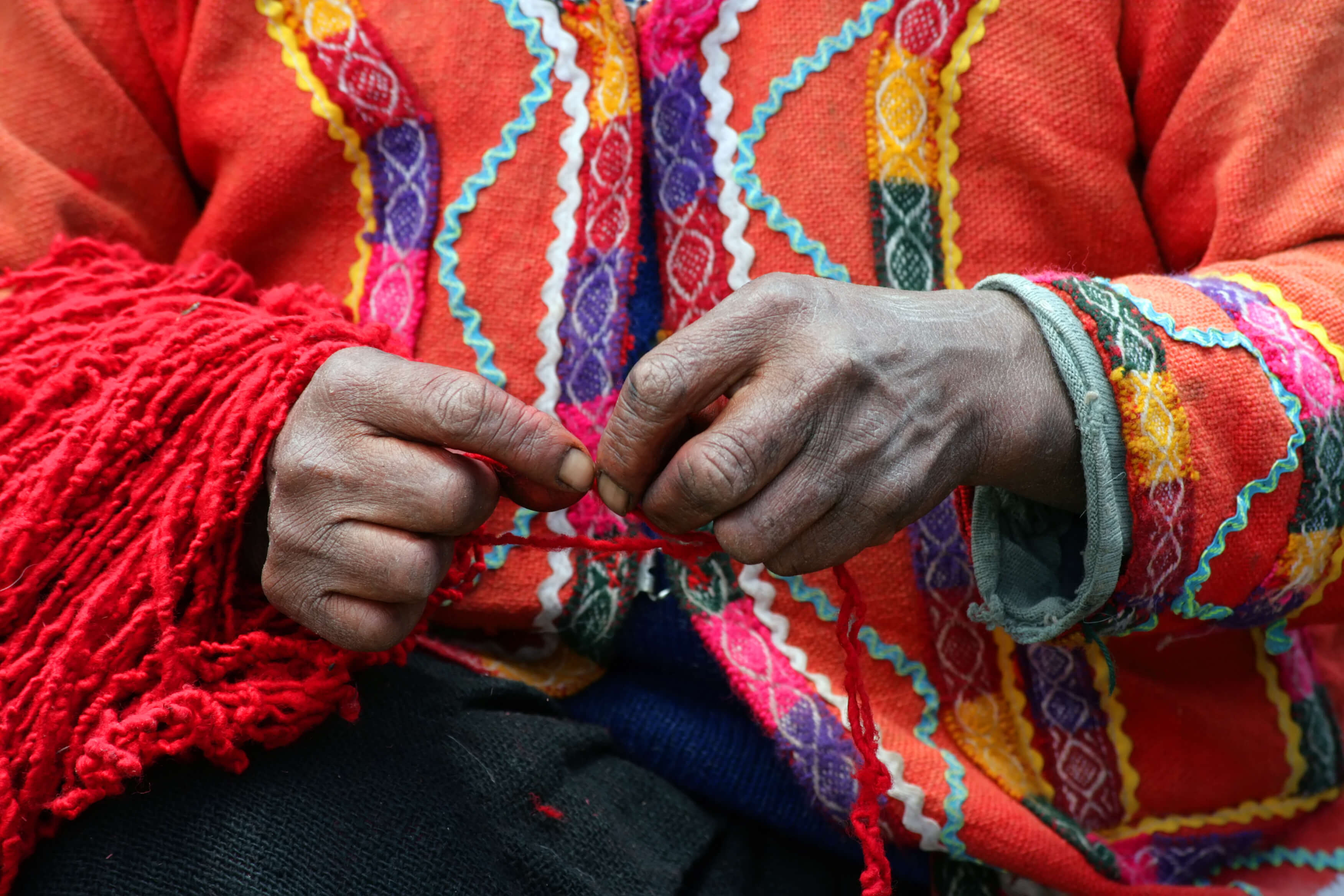 A Peruvian artisan works with hand-spun wool