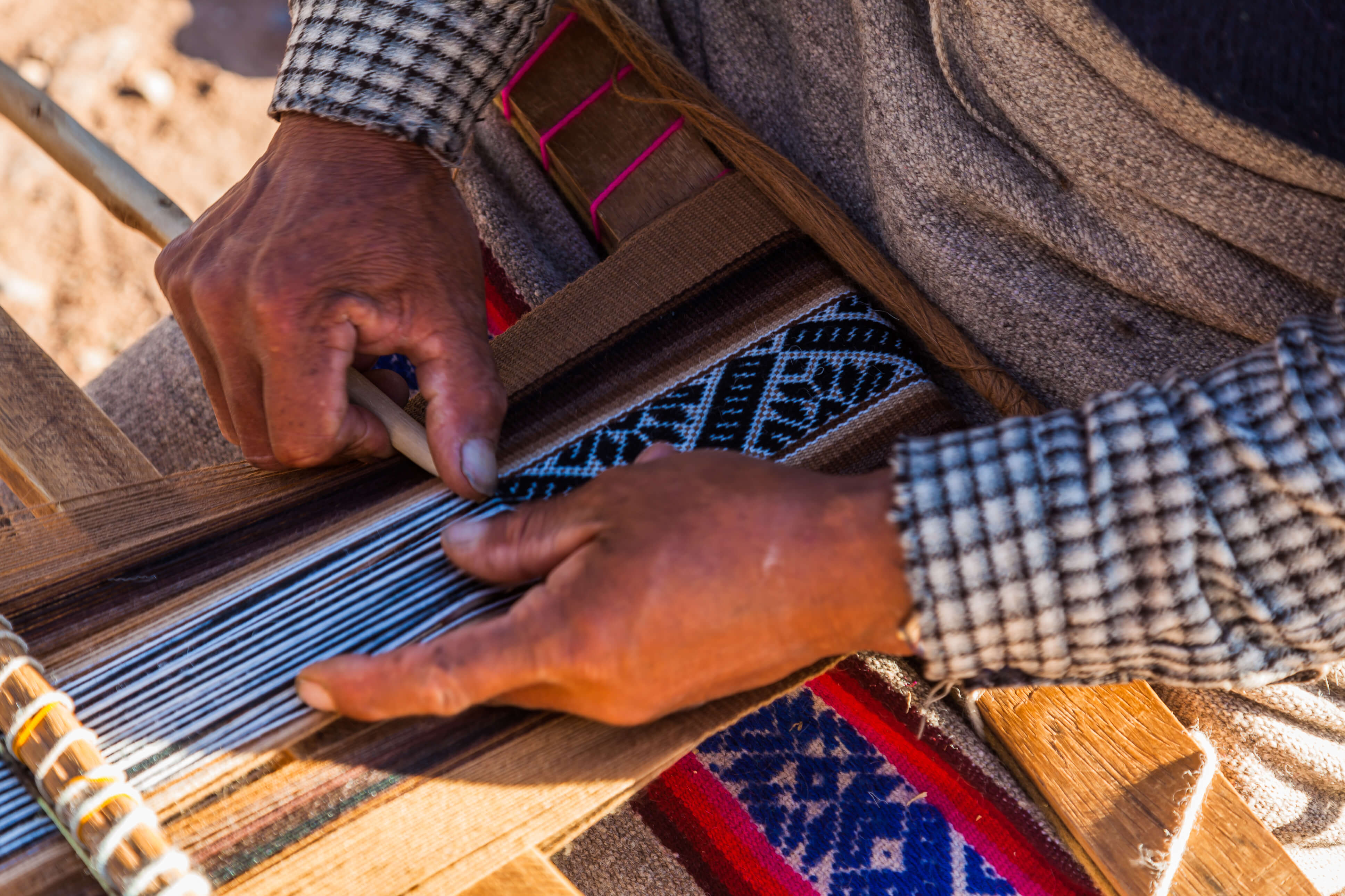 A Woman Weaver Creates an intricate design on her loom 