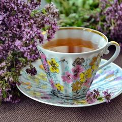tea in a cup on a saucer with lavender next to it
