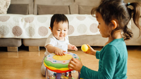 Baby and toddler playing