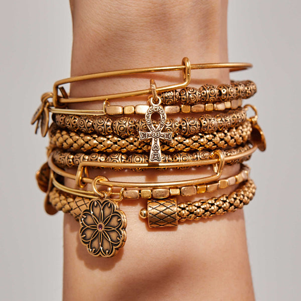 gold bracelets with symbols and texture