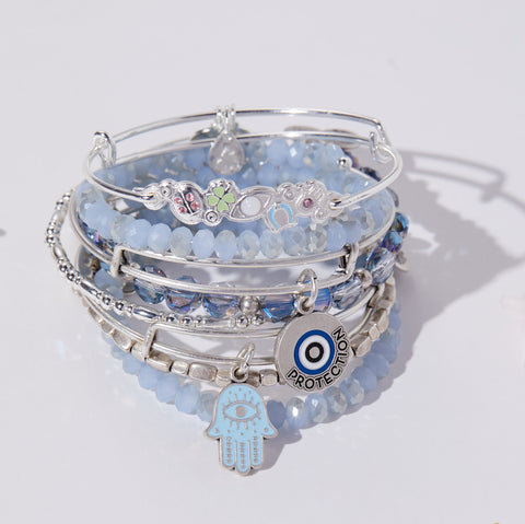 silver and blue bracelets with evil eye and hamsa charms