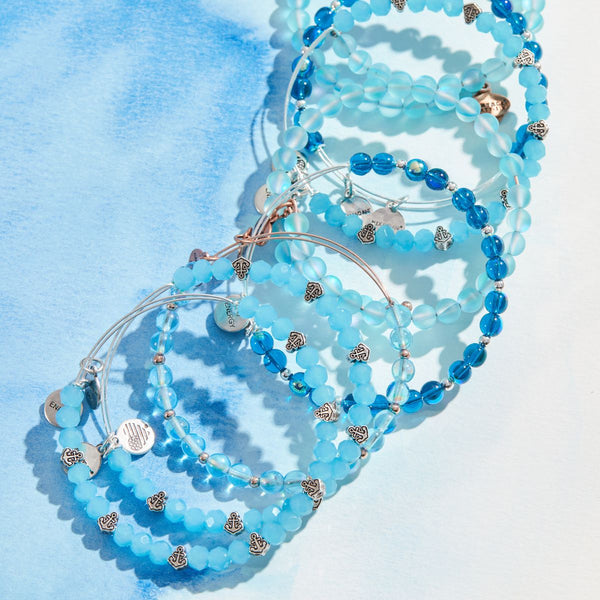 stack of blue bracelets with silver anchor beads