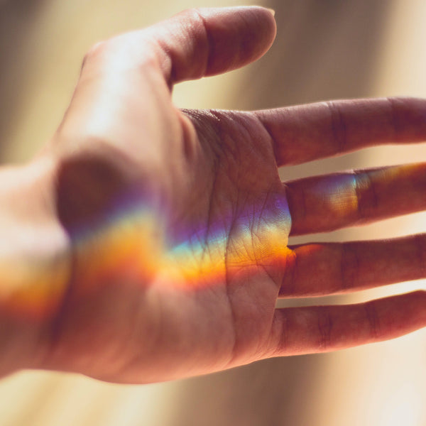 rainbow reflection on hand