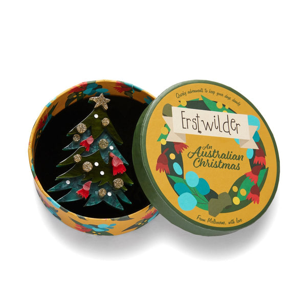 An Australian Christmas Collection "Yuletide Timber" layered resin green decorated tree with star on top brooch, shown in illustrated round box packaging