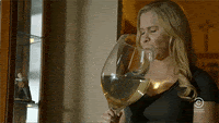Drinking large wine glass wearing Thermaband device for cooling relief