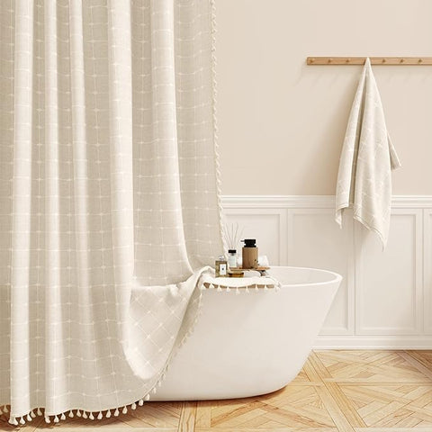 Boho Farmhouse shower curtain in cream color with tassels, adding rustic charm to bathroom decor.