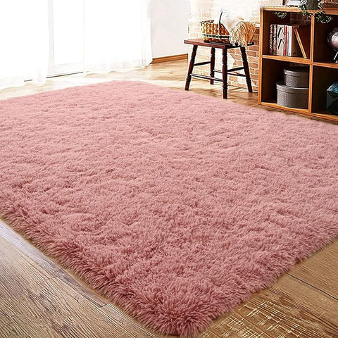 Plush and cozy blush shaggy area rug, perfect for adding warmth and style to any room.