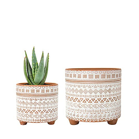 Two terracotta planter pots with geometric design and drainage holes, suitable for bohemian home decor.