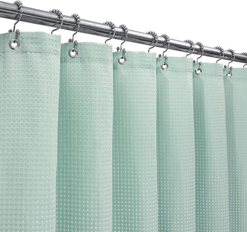 Misty blue waffle-weave shower curtain, evoking a spa-like feel, made from high-quality polyester blend fabric.