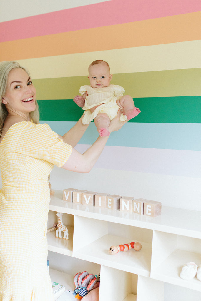 AU Baby Journal. DIY Rainbow wall mural tutorial. How to paint a rainbow wall mural. Gender neutral nursery design ideas. Gender neutral nursery decor ideas.