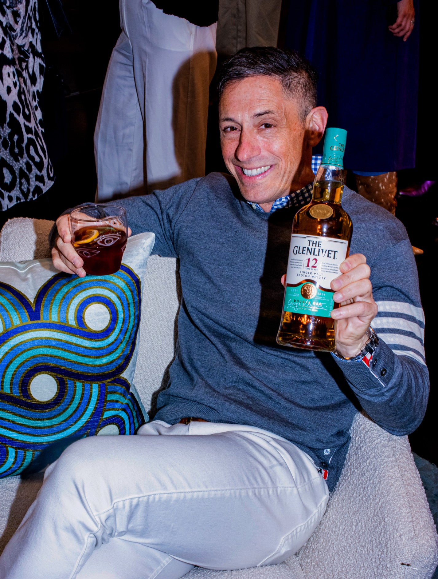 Jonathan holding a bottle of The Glenlivet Single Malt Scotch Whiskey