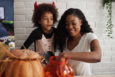 Mother and child smiling with Halloween candy
