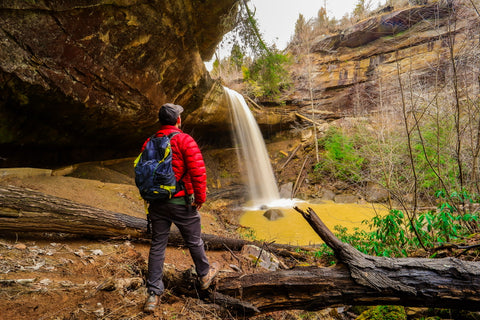 Hiker standing in front of broke leg falls waterfall scenic area kentucky