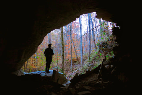 Hiker standing inside of SHANGRA la arch in Carter caves state park Kentucky 