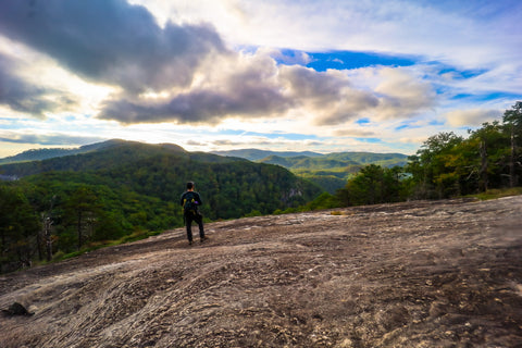 Hiker atop governors rock while summiting table rock state park South Carolina 