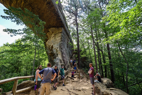 Visitors gathering to hike through fat mans squeeze passage behind natural bridge arch kentucky