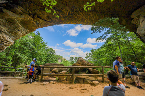 Sitting underneath Natural Bridge Arch in Natural Bridge State Resort Park in Kentucky 