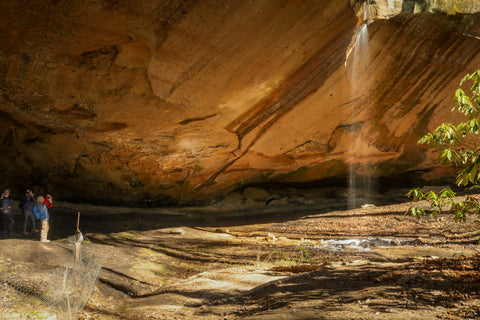 visitors inside of council chamber rock shelter in red river gorge Kentucky 
