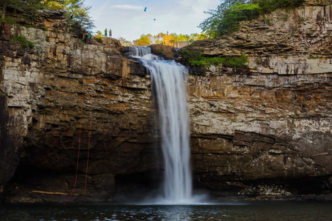 Hikers rappelling off the front of DeSoto Falls Waterfall Picnic Area in northeast Alabama 