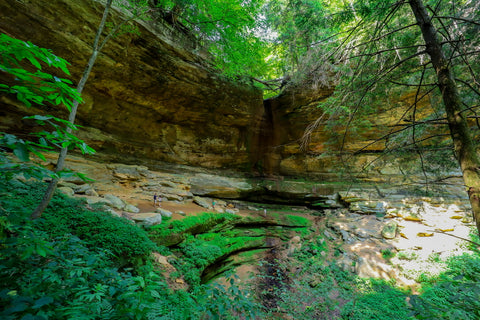Rock shelter and waterfall along gorge trail of Cantwell cliffs in Hocking hills state park ohio