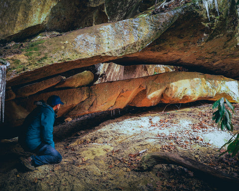 hiker standing beside double deer arch in red river gorge Kentucky 