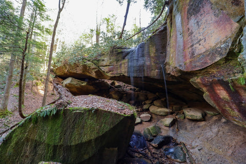 waterfall streaming over whittleton arch in red river gorge kentucky