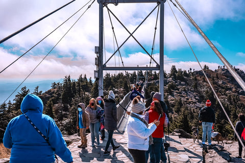 hikers waiting to cross over mile high swinging bridge on grandfather mountain