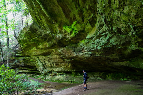 hiker inside Indian Rockhouse within Pickett CCC State Park