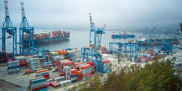 Container port with cargo bay ships on the coastline