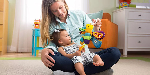 Mom and baby playing with clip on toy