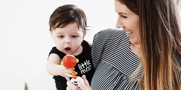 Baby and mom playing with a rattle