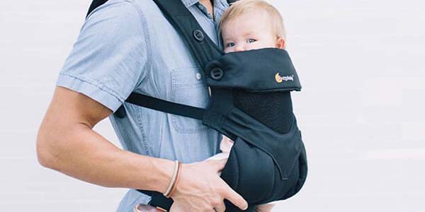 Dad carrying baby in a buckle carrier