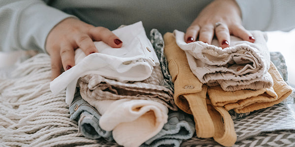 Stacks of newborn's clothing