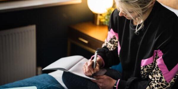 A woman writing on her journal