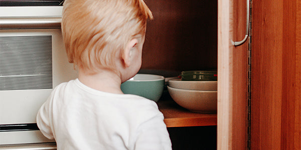 Baby looking for kitchen bowl