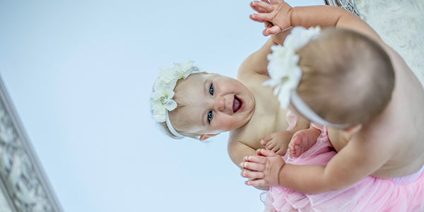 Baby playing with mirror