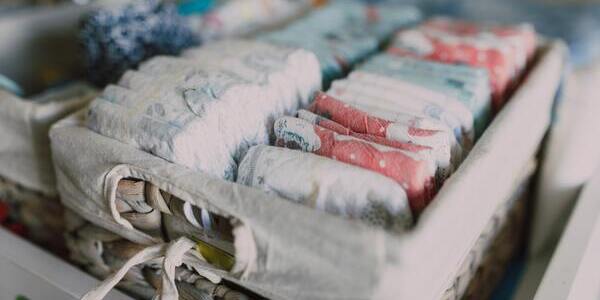 Organized baby diapers folded tightly in a basket