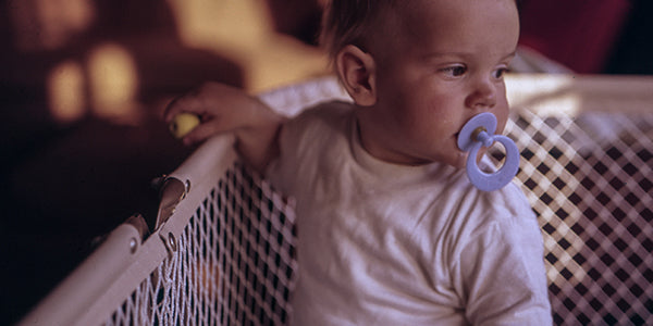 Baby inside of play pen