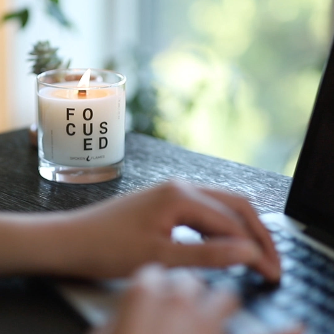 Woman at laptop with candle