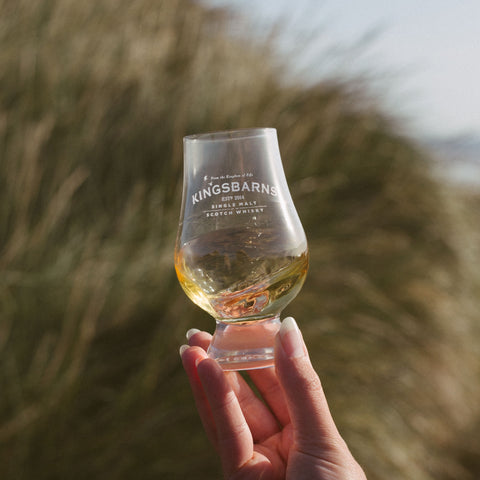 Kingsbarns Glencairn glass with a dram of single malt swirling inside